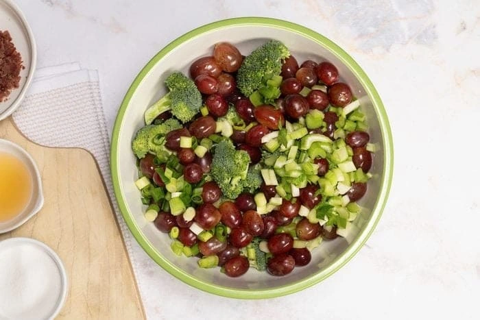 Colourful low-carb salad bowl with broccoli and grapes
